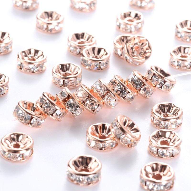 Uniq Perler Metal perler Rosa guld 8 mm rondeller med klar sten. 25 stk.